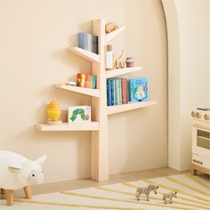 a child's room with a book shelf and toy animals on the rug in front of it