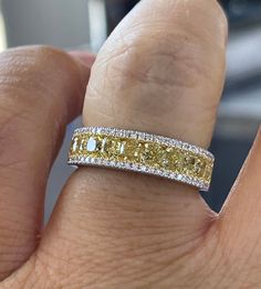 Fancy Yellow Diamond Band is the perfect gift for someone who has it all. It's very different looking and simple and classy. All the diamonds are shiny and sparkles a lot. The diamonds are all set smooth, so won't catch on things. If you like the look of two-tone this band is perfect for you also. The Center yellow diamonds is flanked on each side by 1 row of small white diamonds. The band measures 5.1mm width and tapers 3.8mm at bottom. The band is solid inside, please order 1/2 size bigger for Anniversary Rings With Diamond Accents And Yellow Sapphire, Yellow Rings With Diamond Accents In Fine Jewelry Style, Yellow Platinum Diamond Wedding Ring, Luxury Yellow Rings With Single Cut Diamonds, Yellow Diamond Ring For Wedding, Yellow Diamond Rings With Diamond Accents, Wedding Ring With Yellow Sapphire, Yellow Platinum Diamond Ring, Yellow Gold Fine Jewelry Rings With Diamond Cut