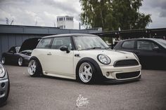 a small white car parked in a parking lot