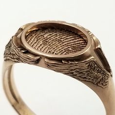 "Free first class shipping on all items with standard gift box! Free priority shipping on orders over $140 with upgraded gift box! U.S. shipments only These memorial rings feature a set of angel wings on each side of the ring with the one being memorialized fingerprint framed in a halo inside the ring. They really are a very nice and fitting. These can be made in silver, yellow gold, and/or white gold. The print can be cut in a different metal than the ring for contrast or they can both be made Unique 14k Gold Signet Ring Gift, Unique Rings With Engraving Option For Gift, Oval Etched Signet Ring As Gift, Unique Oval Engraved Ring As A Gift, Unique Oval Engraved Ring For Gift, Oval Etched Signet Ring Gift, Unique Engraved Oval Ring For Gift, Etched Oval Ring For Gift, Oval Etched Rings For Gift