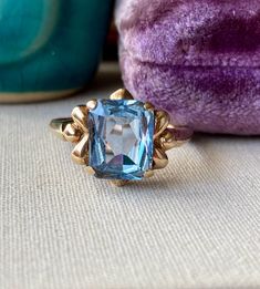 Beautiful blue topaz gemstone vintage ring. Mid-century; circa 1950s - 1970s.  Rectangular blue gemstone testing as a topaz on my gem tester measures approx 10 x 8 mm. Lovely and interesting mounting.  Signed 10K; yellow gold. Weighs 3.26 grams.  Ring size 9 US, resizable.  In very good used vintage condition. Pre-owned, light signs of wear/marks/age.  Add me to your Etsy favorites and see you on Instagram! @luxcharmjewelry - let's be jewelry friends xo Vintage Gemstone Birthstone Ring For Formal Occasions, Collectible Vintage Sapphire Ring, Vintage Birthstone Ring For Formal Occasions, Vintage Collectible Birthstone Ring, Vintage Formal Birthstone Ring, Vintage Blue Oval Sapphire Ring, Vintage Yellow Gold Hallmarked Topaz Ring, Vintage Sapphire Gemstone Ring, Vintage Yellow Gold Topaz Ring, Hallmarked