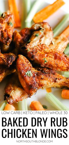 baked dry rub chicken wings on a white plate with carrots and celery