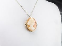 Dating to the retro era period, this cameo represents all the traditions of cameo carving, with a modern era twist! The frame is simple, a looping frame of gold that shines like a ribbon around the bezel. The lady depicted wears her hair in a Retro style, an up-do hairstyle that is chic and lovely. This pendant does not come with the chain shown. Please feel free to contact us, we will help you find the perfect chain for your style and budget! Metal: 14K Yellow Gold Gem: Shell Cameo Gem Measurem Retro Era, Cameo Ring, July Birthstone, The Lady, Hair Updos, Estate Jewelry, Retro Style, Her Hair, Beautiful Rings