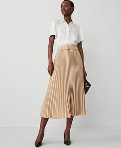 Elevate your wardrobe with the Ann Taylor Belted Pleated Midi Skirt, a perfect blend of modern style and feminine flair. This skirt is designed to make a statement with its elegant pleats and a chic self-tie buckle belt.

- **Size:** 14
- **Color:** Baguette
- **Material:** 100% Polyester
- **Length:** 34 1/4" long
- **Gender:** Female
- **Care Instructions:** Machine Washable

Crafted from lightweight polyester, this skirt ensures comfort and durability. The hidden side zipper with hook-and-eye Pleated Maxi Skirt Work, Pleated Cream Skirt, Corporate Skirt Styles, Long Cream Skirt, Work Outfits Women Skirt, Professional Skirts, Long Pleated Skirt Outfit, Professional Fits, Fun Skirts