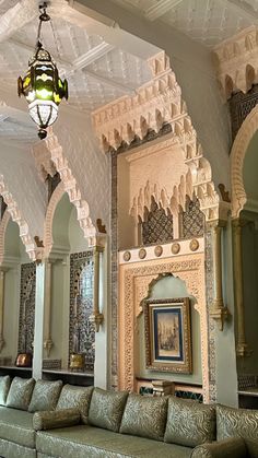 a living room filled with lots of couches and walls covered in intricately designed wall coverings