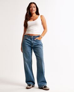 Our Curve Love low rise baggy jeans in a medium wash with a clean hem. This fit features a 8.5” low rise, is slightly relaxed at waist and hips, and eases at the thigh into a baggy, full-length leg shape. We recommend buying your true size for a baggier fit. Size down for a closer fit. The viral fit that eliminates waist gap: Curve Love features additional room through the hip and thigh for curve-hugging comfort. This jean is made from our vintage stretch fabric which features both an authentic Jeans For Big Thighs, Baggy Jeans Outfit, Low Rise Baggy Jeans, Baggy Jean, Abercrombie Jeans, Low Waist Jeans, Women's Bottoms, Cuffed Jeans, Style Inspiration Fall