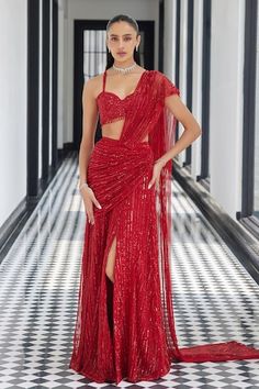 a woman in a red dress standing on a checkered floor