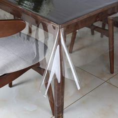 a chair that is sitting under a table with a bow on the back of it