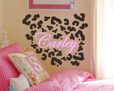 a bedroom with pink and black wall decals in the shape of a leopard print heart