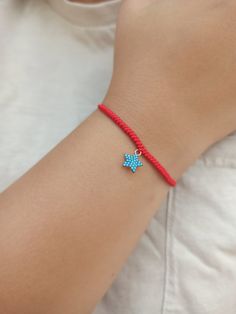 925 k high quality 18k Rose Gold plated star charm with turquoise cz diamonds.  Red string of fate, hand made snake knot woven bracelet.  Minimalist red string bracelet.  All our products are handmade in our workshop with high quality materials. We deliver with branded gift boxes.  Fast delivery.  Great gift for her, gift for mom, gift for mother, gift for girlfriend, friendship bracelets, knotted thread bracelet. Fine Jewelry Star-shaped Gemstone, Trendy Silver Jewelry With Sliding Knot, Star Charm Jewelry Gift, Trendy Star Charm Pendant Jewelry, Trendy Bracelet With Sliding Knot, Adjustable Sterling Silver Charms Jewelry, Adjustable Dangle Jewelry With Star Charm, Adjustable Turquoise Jewelry With Star Charm, Adjustable Dangle Star Charm Jewelry