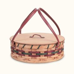 a basket that is made out of wood and has two handles on the top, one with