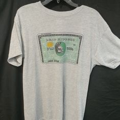 a white t - shirt with an image of a green bank note on it's chest