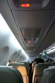 the inside of an airplane with people sitting in it