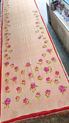 the table cloth has pink flowers on it