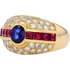 Marvel at the myriad of magnificence with this stunning 18K Yellow Gold Sapphire & Ruby Ring from our exquisite collection. Crafted to capture the essence of timeless elegance, this ring features a captivating Sapphire as its main stone, boasting a total carat weight of 1.58 Carats. Complementing the allure are dazzling Diamonds with a total weight of 0.73 Carats, adding a touch of brilliance to this already mesmerizing piece.The rich, warm tones of 18K Yellow Gold perfectly enhance the vivid colors of the gemstones, creating a harmonious and luxurious aesthetic. Whether worn as a symbol of your personal style or as a cherished heirloom, this ring exudes sophistication and grace.Indulge in the allure of this Estate Jewelry piece and embrace the enchanting beauty that transcends time and tr Luxury Multi-stone Sapphire Gemstones, Luxury Sapphire Diamond Ring With 17 Jewels, Luxury Ruby Ring With Round Cut Gemstone, Luxury Oval Multi-stone Diamond Ring, Luxury Brilliant Cut Sapphire Gemstones, Luxury Ruby Ring With Gemstone Accents For Anniversary, Luxury Ruby Ring With Pave Setting, Luxury Round Cut Gemstones With Center Stone, Luxury Round Cut Center Stone Gemstones