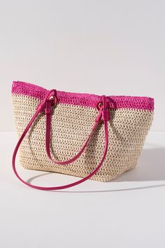 Carry your essentials in style this summer with Shiraleah's Syracuse Tote. The natural woven paper straw is accented with a stripe of fuchsia and features both matching PU handles and shoulder straps to add some versatility to your style. Pair with other items from Shiraleah to complete your look! Features Double Handles, Double Shoulder Straps, Magnetic Snap Closure, And 1 Inner Slip Pocket Shiraleah Is A Trend-Driven Lifestyle Brand Focused On The Little Gifts That Make Life Special! Made From Paper Straw And Pu Measures L 19.5" X W 7" X H 10"; Handles 9"; Strap 15" Made In China Pink Shoulder Beach Bag With Handles, Pink Handwoven Beach Bag, Pink Handwoven Basket Beach Bag, Eco-friendly Pink Rectangular Straw Bag, Artisan Multicolor Straw Bag, Fair Trade, Paper Straws, Woven Paper, Lifestyle Brands, Little Gifts