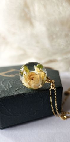 Handmade necklace, made by myself. Necklace made using real tiny white rose and bio organic resin. Chain and findings are from 925 sterling silver 18k gold plated. Pendant dimensions: 20 mm sphere ball Jewellery comes in a unique handmade gift box and will be wrapped with care so it is ready as a gift for yourself or someone special. Jewellery are one of a kind and therefore there might be slight difference between images and the product you will receive. Any questions, please do not hesitate to Delicate Rose Gold Keepsake Jewelry, Rose Gold Necklace With Flower Charm For Keepsake, Rose Gold Birth Flower Jewelry Keepsake, Sterling Silver Rose Design Jewelry For Gift, Elegant Resin Flower Pendant Jewelry, Handmade Rose Jewelry For Gifts, Delicate Necklace With Pressed Flowers For Anniversary, Delicate Sterling Silver Keepsake Necklace, Rose Gold Flower Jewelry For Keepsake