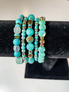 Handpicked Gems and Beads, Crafted into Stunning Stacks: Each piece is meticulously designed and handcrafted with love, ensuring that you receive truly unique and extraordinary accessories. These bracelets are carefully curated to showcase a harmonious blend of colors, textures, and styles. All bracelets are approximately 7.5 inches in length. This stack showcases gorgeous, eye-catching colors of turquoise and gold. Elevate your everyday style with this stunning bracelet stack.✨ #bracelets #jewelry #accessories #handmade #fashion #style #instajewelry #wristcandy #armcandy #jewelryaddict #fashionista #shopsmall #supportlocal #giftideas #braceletstacks #uniquebracelets #handcraftedjewelry #oneofakind #bohostyle #minimalistjewelry #statementjewelry #layeredlook #stackedbracelets #trendyjewelr Turquoise Stretch Bracelet With Round Beads, Turquoise Stackable Stretch Bracelet With Round Beads, Turquoise Stretch Bracelet With Stackable Round Beads, Turquoise Wrap Bracelet With Round Beads As Gift, Unique Turquoise Bracelets With Round Beads, Elegant Handmade Turquoise Beaded Bracelets, Elegant Turquoise Stretch Bracelet As Gift, Turquoise Stackable Bangle Beaded Bracelets, Turquoise Stackable Beaded Bangle Bracelets