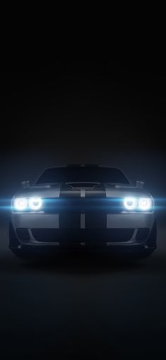 the front end of a black sports car with lights on it's headlight