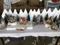 a table topped with snow covered houses and trees