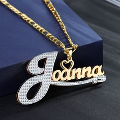 Gold double plated Name Necklace featuring an engraved mini heart charm personalized and custom made with your desired text. Our double plated jewelry is handcrafted with 14K Gold-filled Stainless Steel meaning it is waterproof, hypoallergenic, tarnish-resistant, and everlasting. These are the perfect gifts for the King and Queen in your life. They scream elegance, luxury, and style all while being friendly to your pockets! DETAILS -Waterproof, tarnish-resistant, rust-resistant, hypoallergenic a Personalized White Gold-plated Name Necklace, Elegant Silver Chain Necklace With Custom Name, Elegant Name Pendant Chain Necklace, Anniversary Silver Name Necklace With Figaro Chain, Customized Nameplate Chain Necklace, Elegant Pendant Chain Necklace With Name, Custom White Nameplate Necklace, Silver Name Chain Necklace For Anniversary, Silver Gold Plated Name Necklace For Anniversary