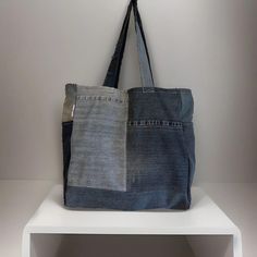 Denim handmade shoulder bag width 39cm length 40cm.  ✨Each bag is a one of a kind as it is made from responsibility sourced denim, and made by hand in our UK based studio. ✨The bags are a square shape and have a panel on the bottom which allows for plenty of storage space. There is also a pocket on each side panel. Our super cute "reworked by Ruthie" label is featured on the side of the bag. ✨The bags are made of a single layer of denim and are finished with an overlocked stitch on the inside of Rectangular Denim Blue Shoulder Bag For Everyday Use, Handmade Denim Tote Shoulder Bag, Vintage Denim Blue Shoulder Bag For Everyday, Vintage Denim Blue Everyday Shoulder Bag, Dark Wash Recycled Denim Tote Bag, Daily Use Denim Shoulder Bag With Flat Pocket, Vintage Denim Blue Bags For Everyday Use, Rectangular Dark Wash Shoulder Bag For Everyday Use, Everyday Rectangular Dark Wash Shoulder Bag