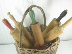 an old basket filled with different types of wooden utensils