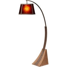 a lamp that is on top of a wooden base and has a red glass shade