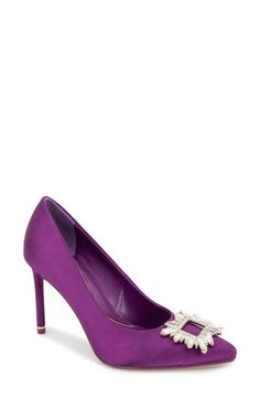 A jewel-encrusted ornament adorns the vamp of an elegant satin pump framed by a pointy toe and stiletto heel. 3 1/2" heel Cushioned footbed Textile upper/synthetic lining and sole Imported Purple Pointed Toe Slingback Pumps For Evening, Purple Pointed Toe Heels With Reinforced Heel, Chic Purple Pointed Toe Heels, Purple Leather Pointed Toe Heels, Purple Pointed Toe Heels With 4-inch Heel, Purple Satin, Satin Pumps, The Vamps, Kenneth Cole