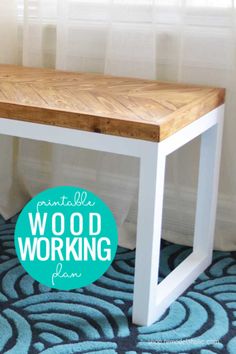 a wood work bench sitting on top of a blue rug in front of a window