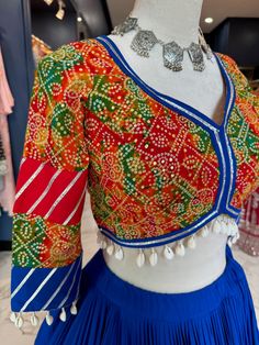 Ready to Ship! TO ORDER LARGER SIZES, PLEASE WHATSAPP +1 (945) 444-2194 Royal Blue cotton Chaniya choli Printed blouse crafted with sleeves with a paan neckline Paired with beautiful vintage georgette royala blue dupatta. Skirt Length: 39.5 Max Blouse Chest Size: 42 Blouse Length: 14 WASH CARE INSTRUCTION: Dry clean only. Slight variation in color is possible due to digital photography. Shipping will take 5 business days, Please WHATSAPP +1 (945) 444-2194 for more info and further customizations Bohemian Style Blouse With Bandhani Print For Wedding, Traditional Georgette Tops With Dupatta, Georgette Tops With Dupatta For Festivals, Multicolor Long Sleeve Anarkali Set For Navratri, Bohemian Georgette Choli For Navratri, Blue Georgette Choli For Transitional Season, Traditional Navratri Tops With Dupatta, Bohemian Georgette Choli For Designer Wear, Bohemian Multicolor Blouse With Dupatta