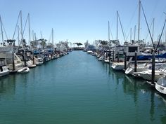 the boats are docked in the water at the marina