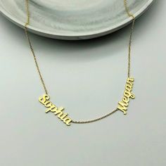 "14k Two Name Necklace * Double Name Necklace * Material : 14k Solid Gold - 8k Solid Gold * Finish : White Gold - Yellow Gold - Rose Gold * Production Method : Laser and handmade processes * Lenght: Adjustable Between 14 inch - 22 inch *Lowercase Height : 5 mm A Necklace that your neck will seriously loveee. This name necklace is perfect for everyday. * 100% Handmade for your size * All jewelry comes in beautiful packaging, gift ready. * All items are made to order in Turkey. * Our current proce Luxury Custom Name Necklace In Sterling Silver, Luxury Custom Sterling Silver Name Necklace, Silver Nameplate Necklace Stamped 14k, Luxury Necklaces For Gifts, 14k Gold Name Necklace With Round Shape, 14k Gold Round Necklace With Name Detail, 14k Gold Round Necklace With Name, Luxury Custom Yellow Gold Name Necklace, Fine Jewelry Name Pendant Necklace