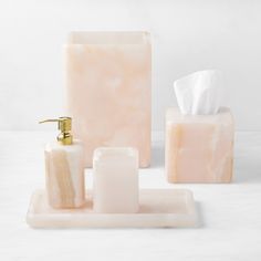 soap dispenser, toothbrush holder and soap dish on marbled surface