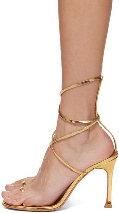 Patent lambskin heeled sandals in gold tone. · Open toe · Single-toe strap · Wraparound ankle strap · Logo embossed at lambskin footbed · Covered stiletto heel · Polished leather sole with rubber injection · Heel: H4.25 Supplier color: Gold Denim Heels, Latest Sandal, White Sandals Heels, Amina Muaddi, Suede Lace, Black Sandals Heels, Lace Up Sandals, Open Toe Sandals, High Heel Sandals