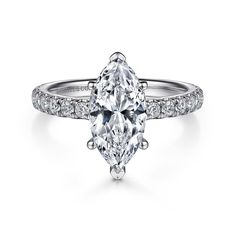 an oval cut diamond engagement ring with pave set shoulders