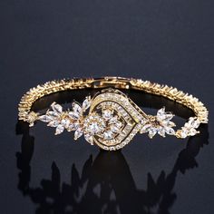 A classy bracelet in art deco vintage inspired style. Featuring intricately faceted cubic zirconia that catch the light from every angle, the bracelet is rhodium / rose gold / yellow gold plated for a flawless finish which perfectly enhances the intricate detailing and conveys a modern take on old elegance. Length: 7" (approx. 18cm); Width: 1" (approx. 2.6cm). Closure is a secure fold-over clasp. Weight: 14g.Choose between Silver, Rose Gold and Yellow Gold finishes. To make your choice select yo Elegant Rose Gold Cubic Zirconia Diamond Bracelet, Elegant Bracelet With Sparkling Stones For Anniversary, Elegant Bracelets With Sparkling Stones For Anniversary, Elegant Hand Set Rose Gold Tennis Bracelet, Elegant Hand-set Rose Gold Tennis Bracelet, Elegant Crystal Chain Bracelet For Gift, Elegant Rose Gold Bangle Tennis Bracelet, Elegant Cubic Zirconia Bracelets As Gift, Elegant Cubic Zirconia Bracelets For Gifts