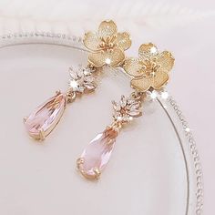 Pink Floral Earrings for brides, weddings and bridal showers. The perfect gift earrings for bridesmaids, mother of the groom, or mother of the bride. Find earrings for bridal bachelorette party or other special occasions here. A gentle cascade of gold flowers and  shimmering Pink crystals in these beautiful nature-inspired bridal earrings. Adding just a hint of sparkle, this pretty pair make gorgeous earrings for both brides and bridesmaids.  Light Pink glass crystals add a fun pop of color and Pink Floral Jewellery, Pink And Gold Earrings, Bridesmaids Pink, Earrings For Bridesmaids, Jewelry For Wedding, Pink Flower Earrings, Bride Floral, Bridal Bachelorette Party, Clutch Bag Wedding