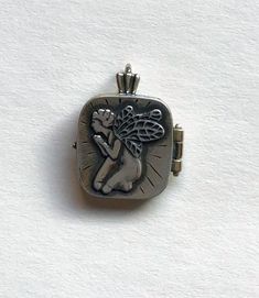 Sterling silver praying angel locket closes with a small magnet. Charm is 1" high x 3/4" wide. Can hold a small photo or written note. Spiritual Silver Locket Necklace For Memorial, Angel Locket, Praying Angel, Small Photos, Small Magnets, Locket Necklace, Locket, Jewelry Necklaces, Accessory Gift