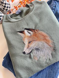 The beautiful fox Embroidered design, perfect for all those cozy nature lovers out there. Made on a Hanes Eco Smart or Gildan Crewneck. Message shop if interested in comfort colors. Cozy Nature, Embroidered Crewneck, Embroidered Design, Nature Lovers, Comfort Colors, Halloween Shopping, Portland, Sweat Shirt, Beauty Book