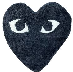 a heart shaped rug with eyes drawn on the front and back of it's face