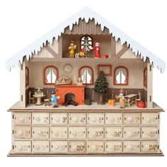 a doll house with lots of furniture and decorations on it's sides, including a christmas tree