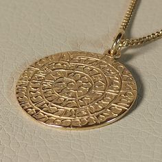 Pendant of phaistos disk made of 15K solid gold A simple classic pendant, perfect workmanship Exelent finishing and polishing ,handmade in Greece The Phaistos disc is a disc of fired clam from the  Minoan palace of Phaistos on the island Crete The disc is about  15 cm.in diameter and covered  on both sides with a spiral of  stamped symbols It is now on display at the archaeological museum of Heraklion, The disc was discovered in 1908 by the Italian archaeologis Luigy Pernier A wonderful gift  that can be worn by men  and women (  Price not include the chain ) Amulet Style Yellow Gold Sterling Silver Coin Necklace, Amulet Sterling Silver Coin Necklace In Yellow Gold, Gold Coin Necklace With Large Symbolic Pendant, Symbolic Yellow Gold Coin Necklace, Symbolic Yellow Gold Coin Pendant Necklace, Engraved 14k Gold Amulet Coin Necklace, 14k Gold Spiritual Coin Necklace With Round Pendant, 14k Gold Round Pendant Amulet Coin Necklace, Yellow Gold Plated Coin Necklace