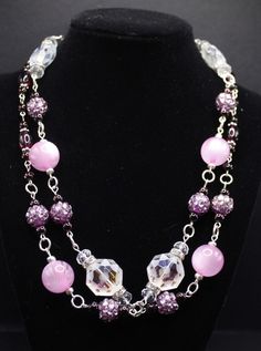 This necklace set has a combination of purple round glass beads with large white/clear Octagon crystals and resin purple glitter beads accented with rhinestone spacers which truly makes this necklace unique and charming!   I also used bright silver metals to give it that extra zing.  This necklace is all 'handmade' utilizing 'eye pins' which makes this necklace sing when wearing due to the movement of the beads.  Since it has all the shining glitter, it actually changes color in the sunlight and Purple Faceted Beads For Jewelry Making, Silver Crystal Necklaces With Large Beads For Jewelry Making, Pink Amethyst Round Beads Jewelry, Purple Crystal Necklace With Faceted Beads, Pink Amethyst Bead Jewelry, Pink Amethyst Jewelry With Round Beads, Purple Faceted Beads Round Beaded Necklace, Purple Round Beaded Costume Jewelry, Purple Beaded Necklace With Faceted Beads