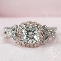 an engagement ring with a princess cut diamond surrounded by round diamonds