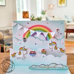 a card with some unicorns and rainbows on it