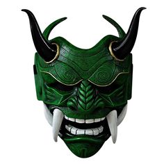 a green mask with horns and fangs on it