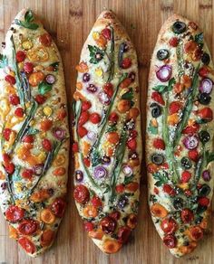 three different types of bread with vegetables on them