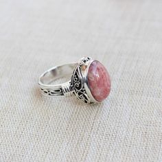 Gemstone - RhodochrositeGemstone Size - 12x16 oval Metal - Sterling SilverRing Size - All sizes AvailableNatural pink rhodochrosite sterling silver handmade ringRhodochrosite attracts love by opening up the heart chakras with its healing vibrations. It gives us the inner strength to take another chance at love because even if you fall, the Rhodochrosite crystal will always catch you.The ring can be customized on request and gemstone can be switched to any gemstone you want. Feel free to contact Rhodochrosite Crystal, Office Jewelry, Plus Size Rings, Pink Rhodochrosite, Handmade Jewelry Box, Healing Vibrations, Onyx Jewelry, Matching Jewelry, Handmade Rings