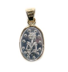 A hand-made piece of jewelry that honors Our Lady of the Miraculous Medal Classic, sturdy, and evocative Mexican medal Genuine silver from Mexico and a 14k solid gold bezel. The elegance of the medal is enhanced by the two-tone metals The medal is a work of art and unique, but it's appealing to everyone One of the devotional medals that are worn the most often across the country is the Our Lady of the Miraculous Medal. The narrative of the medal's inception begins in Paris, France, where three a Spiritual Engraved White Gold Jewelry, Engraved Spiritual White Gold Jewelry, Engraved White Gold Spiritual Jewelry, Symbolic Medallion Jewelry For Commemoration, White Gold Miraculous Medal Round Pendant, 14k Gold Medallion For Commemoration, Memorial Medallion Jewelry With Charms, Symbolic Engraved White Gold Jewelry, Memorial Miraculous Medal Pendant Jewelry